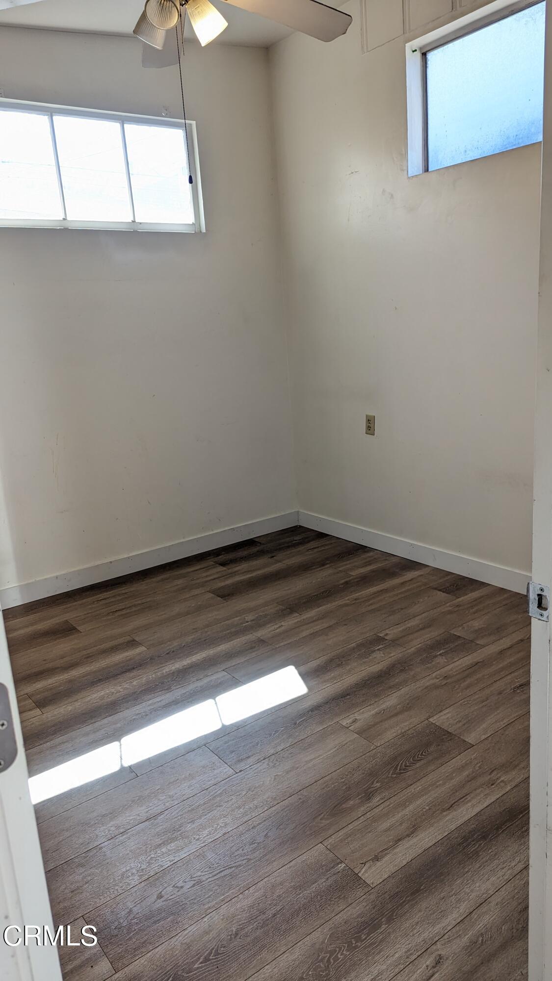 324 Cahuenga Drive Oxnard, CA 93035 - Photo 11 of 17 a view of a room with wooden floor and fan
