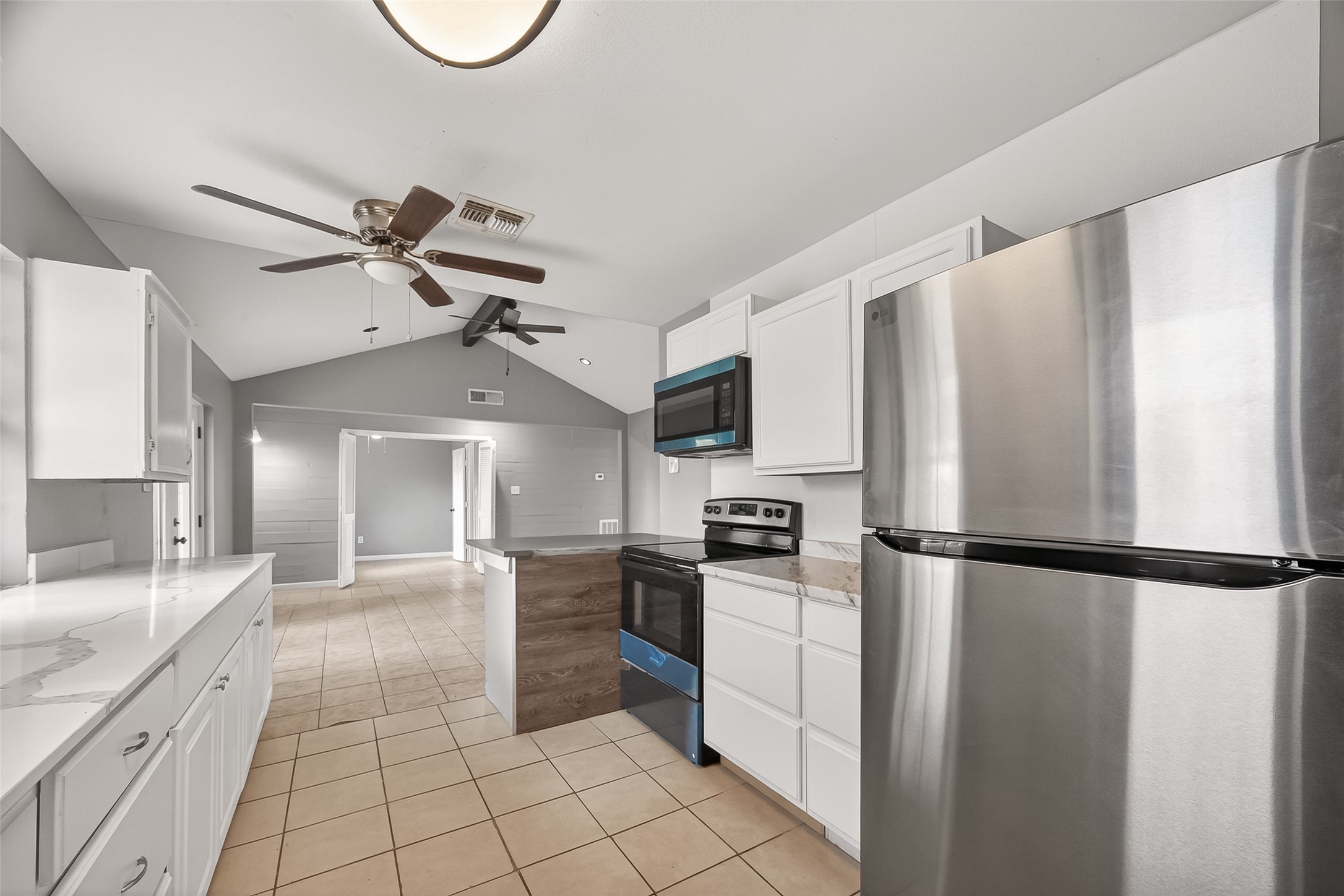 11927 Flushing Meadows Drive Houston, TX 77089 - Photo 12 of 36 a kitchen with stainless steel appliances granite countertop a refrigerator a stove a sink and white cabinets