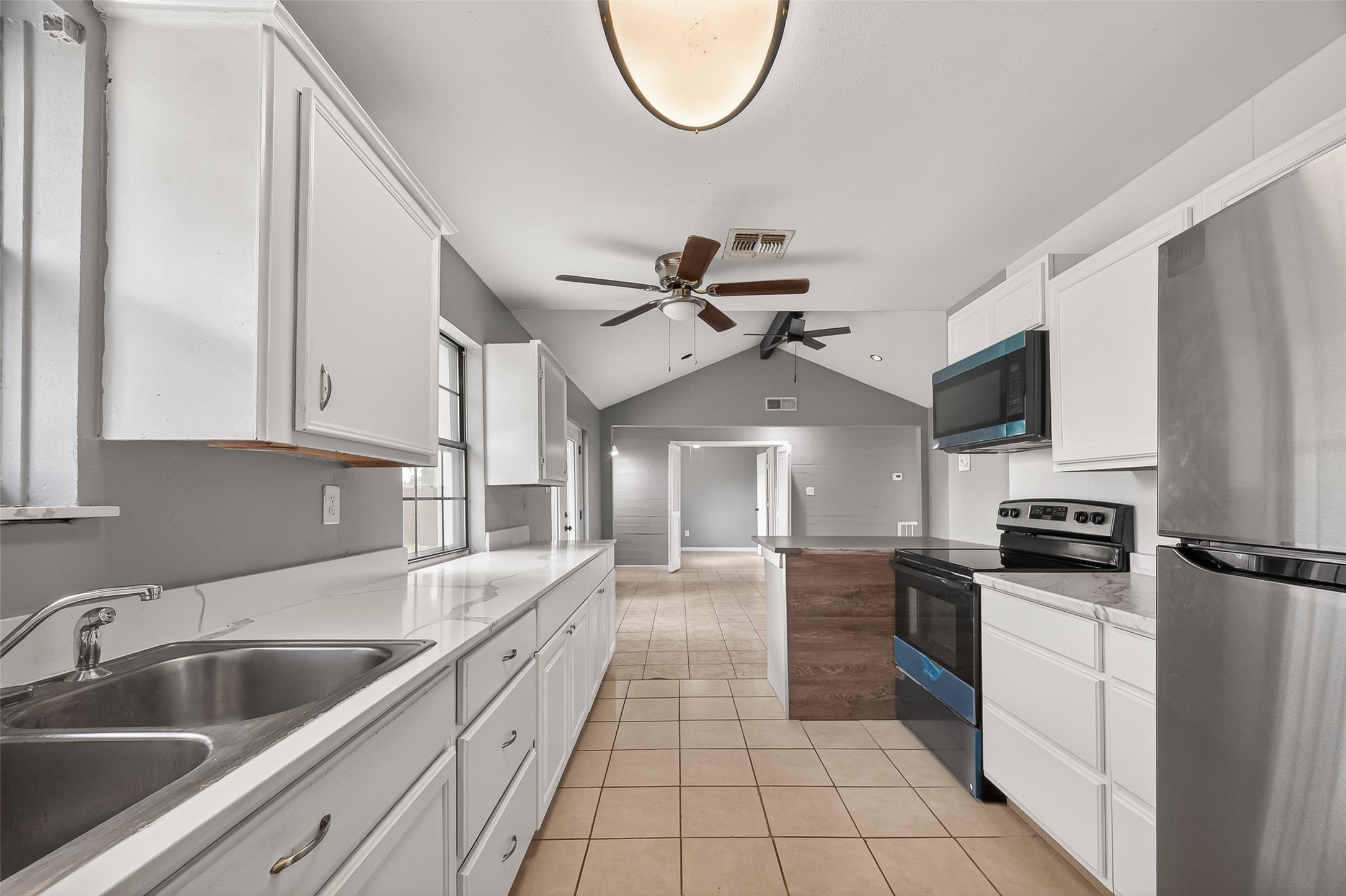 11927 Flushing Meadows Drive Houston, TX 77089 - Photo 13 of 36 a kitchen with granite countertop a sink a counter top space stainless steel appliances and cabinets