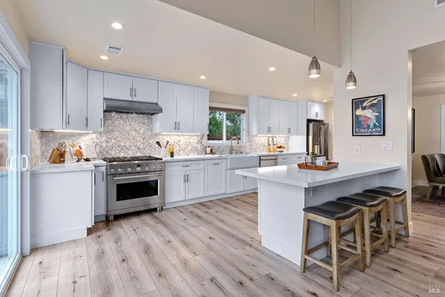 a kitchen with a stove a sink and a refrigerator