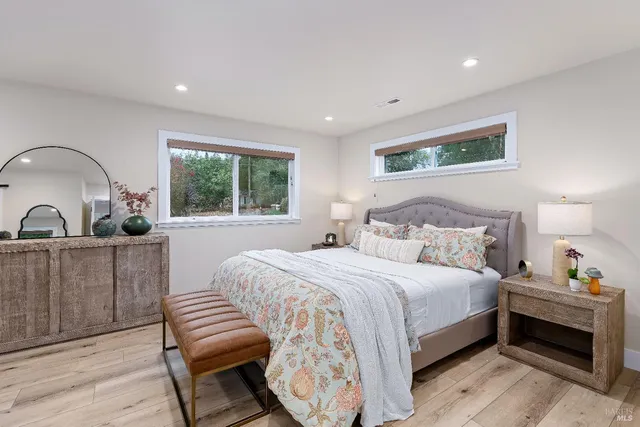 a bedroom with a bed and a large window