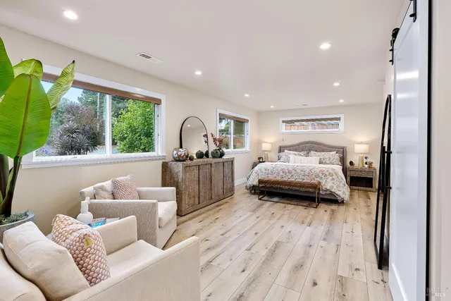 a bedroom with furniture and a wooden floor
