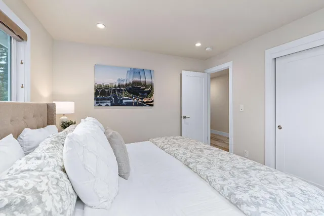 a bedroom with a large bed and a chandelier