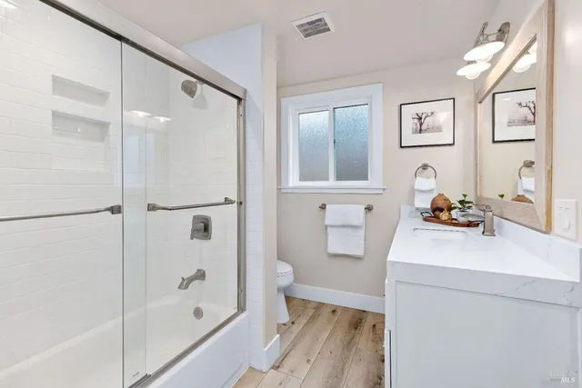 a bathroom with a sink toilet and shower