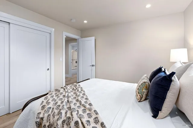 a bedroom with a bed and a lamp