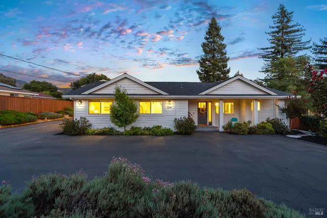 a view of a house with a garden and pathway