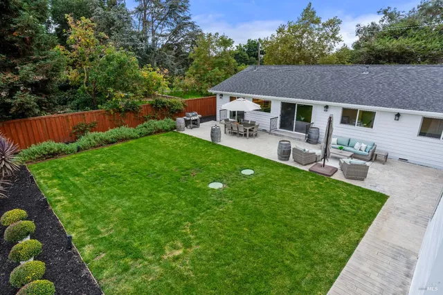 an aerial view of a house with a garden and lake view
