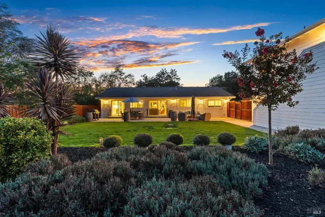 an aerial view of a house with swimming pool outdoor seating and yard