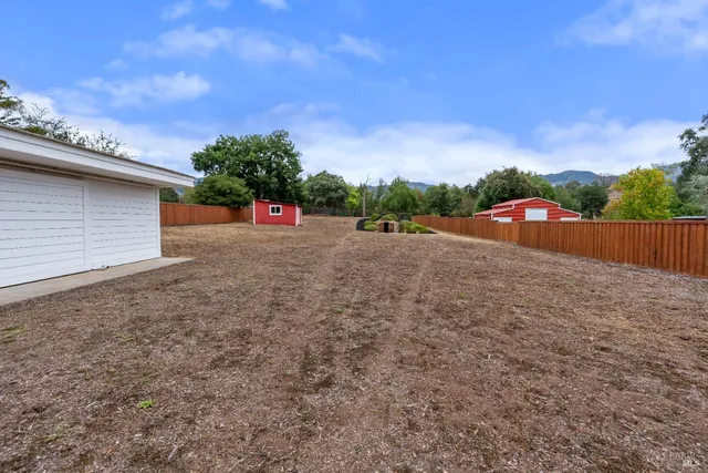 a view of a swimming pool with a yard