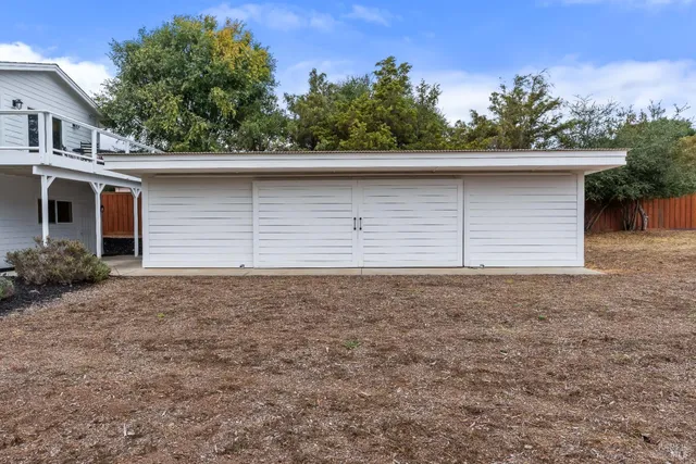 an aerial view of a house with garden space and a car park
