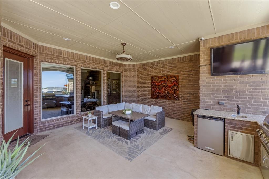 10106 Prather Road Springtown, TX 76082 - Photo 26 of 40 a living room with furniture and a flat screen tv