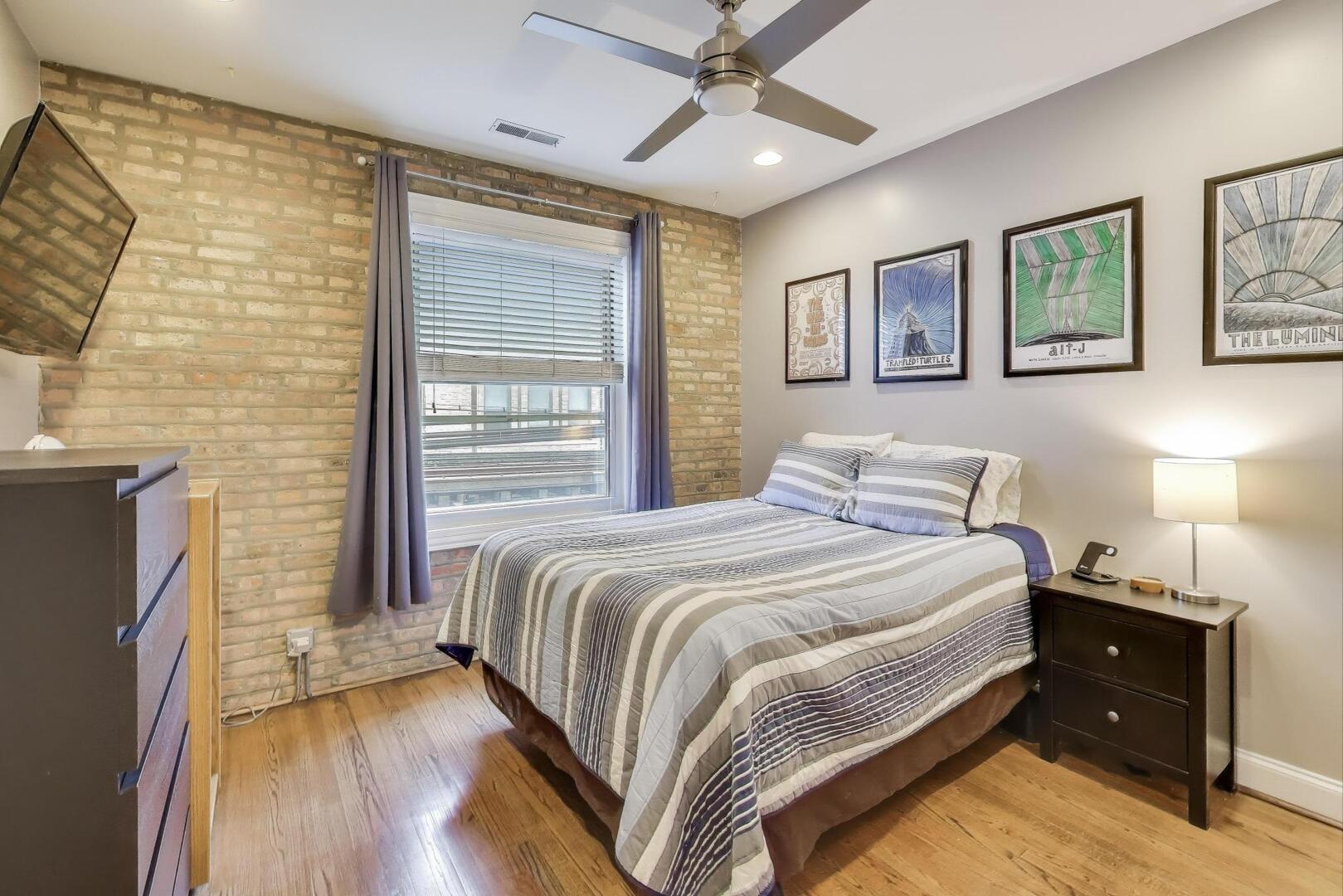 1378 North Wolcott Avenue, Unit 2C Chicago, IL 60622 - Photo 8 of 15 a bedroom with a bed and a chandelier