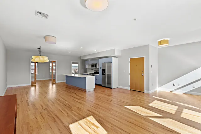 a view of empty room with wooden floor