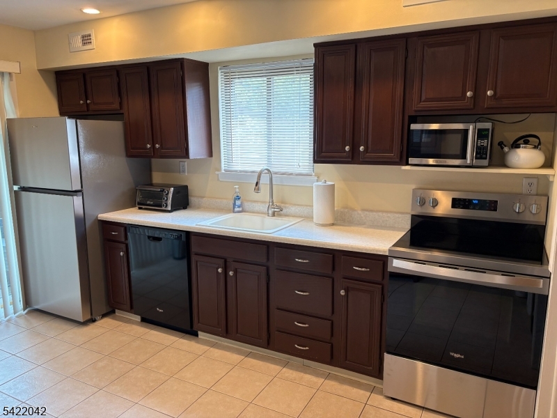 498 Auten Road Hillsborough, NJ 08844 - Photo 15 of 30 a kitchen with a sink a stove and refrigerator