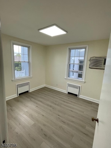8 Fairview Avenue Secaucus, NJ 07094 - Photo 13 of 16 an empty room with wooden floor and windows