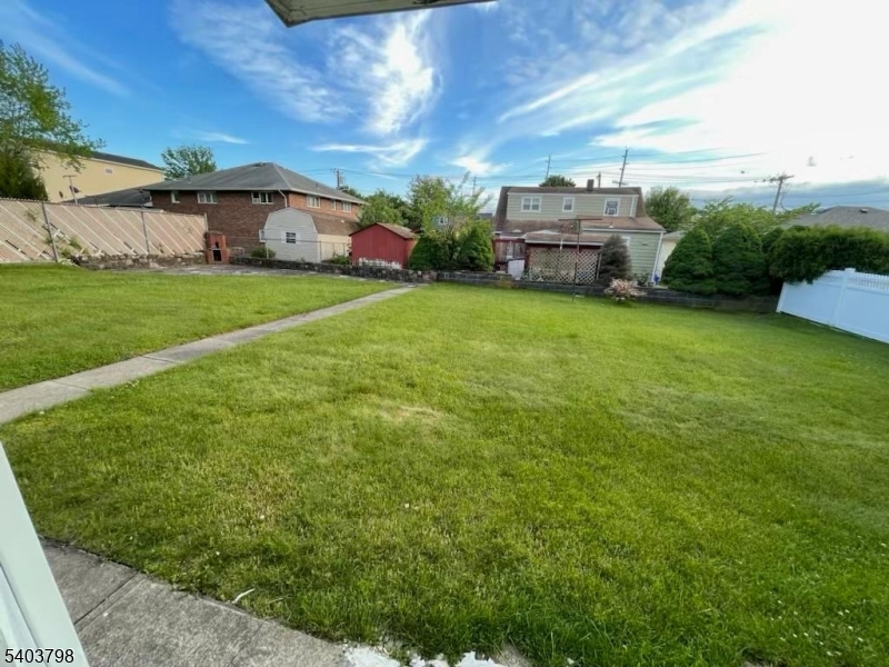 8 Fairview Avenue Secaucus, NJ 07094 - Photo 3 of 16 a view of yard with house and car parked in the background
