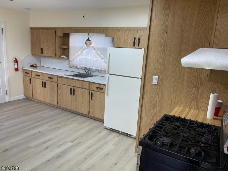 8 Fairview Avenue Secaucus, NJ 07094 - Photo 6 of 16 a kitchen with stainless steel appliances granite countertop a stove and a refrigerator
