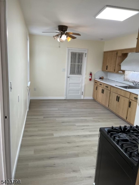 8 Fairview Avenue Secaucus, NJ 07094 - Photo 7 of 16 a kitchen with a stove and white cabinets