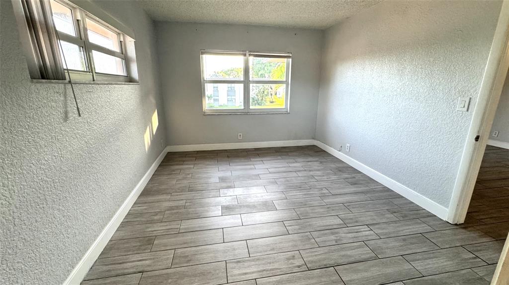 770 Southeast 2nd Avenue, Unit A207 Deerfield Beach, FL 33441 - Photo 11 of 27 an empty room with windows