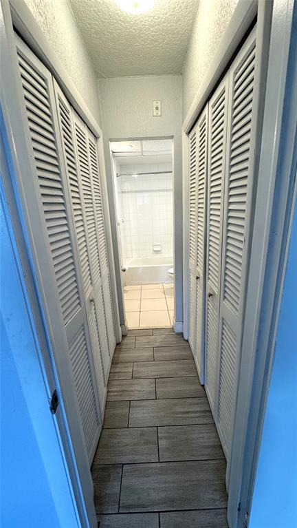 770 Southeast 2nd Avenue, Unit A207 Deerfield Beach, FL 33441 - Photo 13 of 27 a view of a hallway with wooden floor and staircase