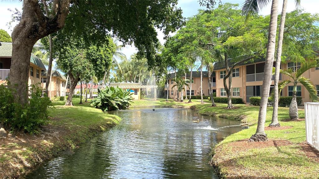 770 Southeast 2nd Avenue, Unit A207 Deerfield Beach, FL 33441 - Photo 18 of 27 a view of swimming pool with lawn chairs and plants