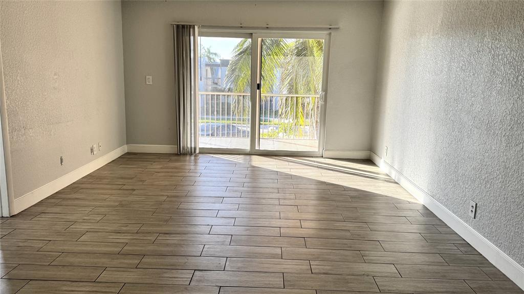 770 Southeast 2nd Avenue, Unit A207 Deerfield Beach, FL 33441 - Photo 2 of 27 a view of an empty room with glass door