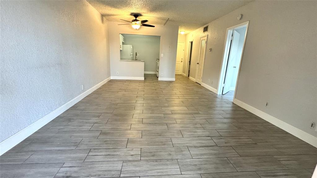770 Southeast 2nd Avenue, Unit A207 Deerfield Beach, FL 33441 - Photo 4 of 27 a view of a hallway with wooden floor and a bathroom