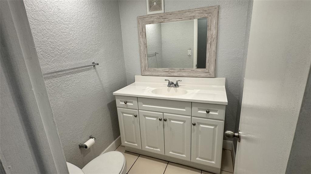 770 Southeast 2nd Avenue, Unit A207 Deerfield Beach, FL 33441 - Photo 7 of 27 a bathroom with a sink vanity mirror and toilet