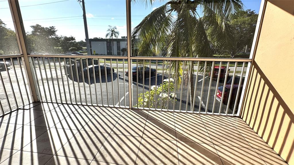 770 Southeast 2nd Avenue, Unit A207 Deerfield Beach, FL 33441 - Photo 8 of 27 a view of balcony with wooden floor and fence