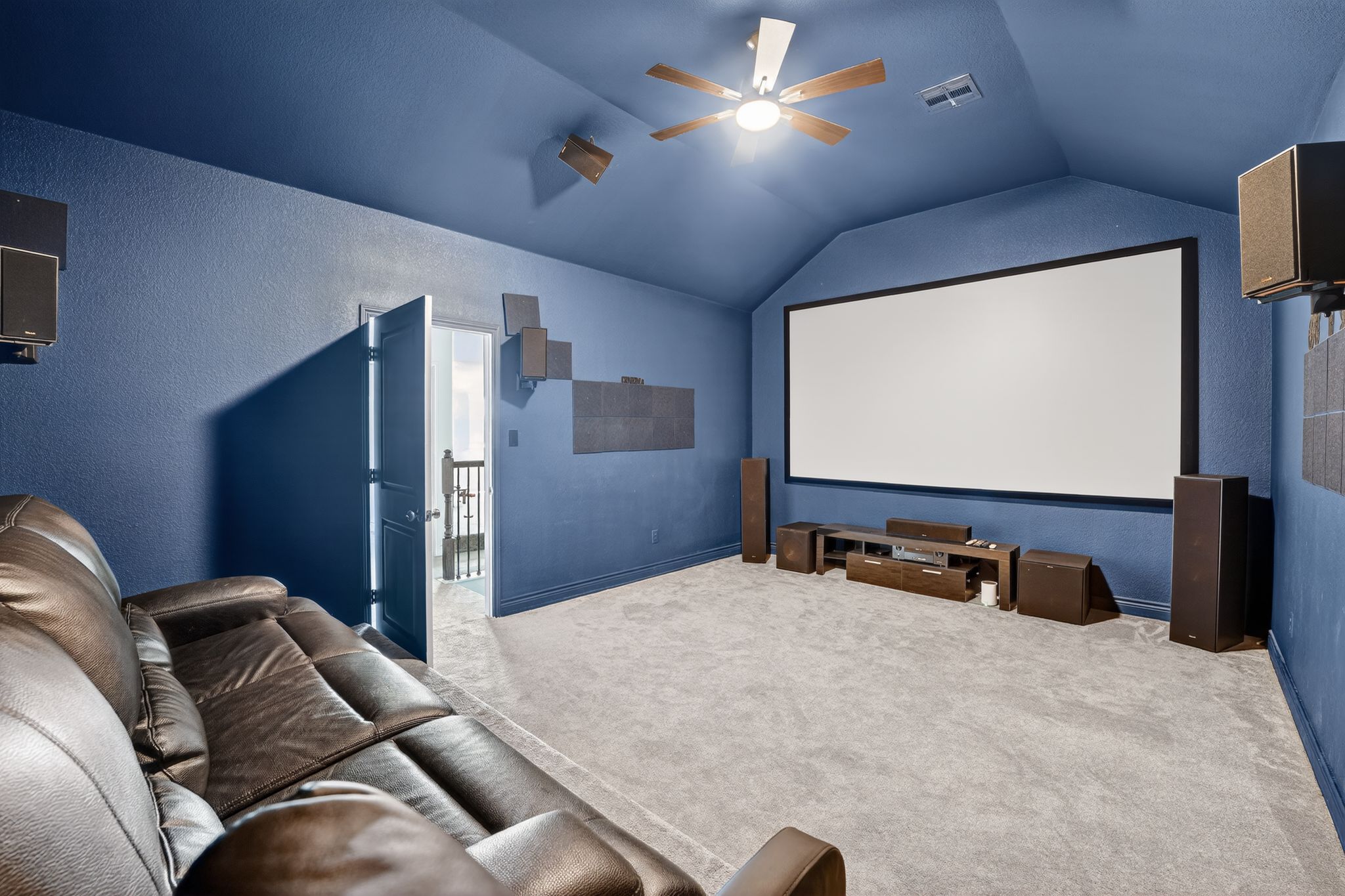 400 Cortona Lane Georgetown, TX 78628 - Photo 34 of 40 Home theater room with a ceiling fan, carpet, and a textured wall