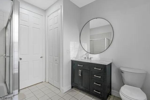 a bathroom with a sink mirror toilet and a mirror