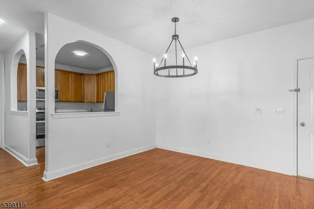 a view of a room with wooden floor and staircase