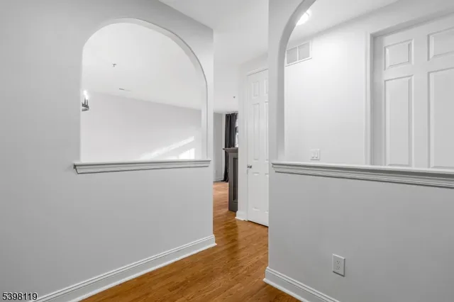a view of empty room with wooden floor