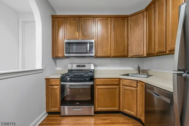 a kitchen with a sink stove top oven and cabinets