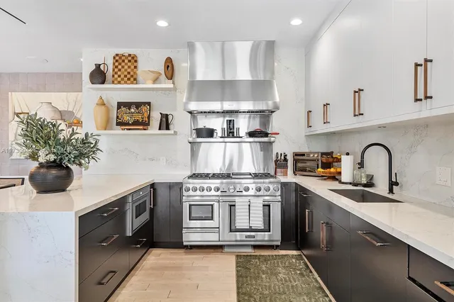 a kitchen with stove top oven and cabinets