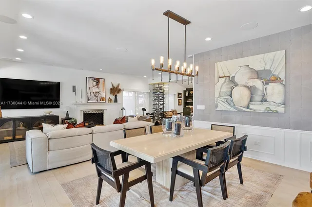 a very nice looking living room with a large window and dining table