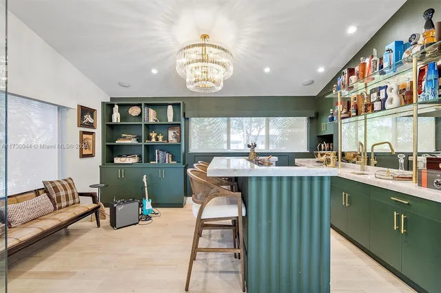 a dining hall with granite countertop a stove a sink and a large window