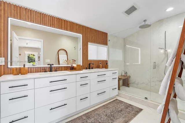 a bathroom with a shower sink and mirror