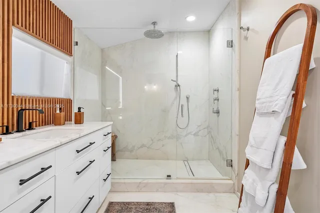 a bathroom with a shower and a sink