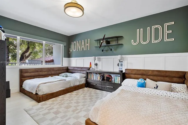 a bedroom with a large bed and a window