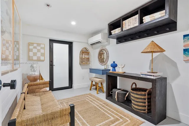 a hallway with white cabinets and wooden floor