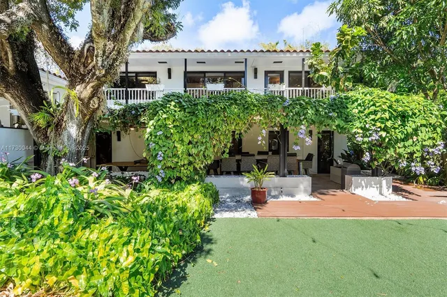 a view of a patio with a table chairs and a swimming pool