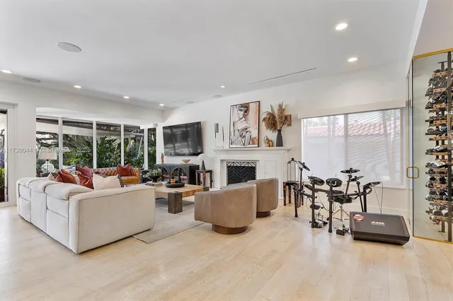 a living room with furniture a large window and a fireplace