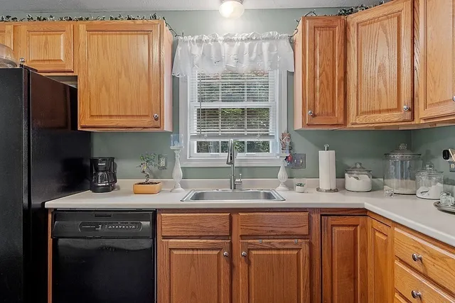 a kitchen with stainless steel appliances granite countertop a sink and cabinets