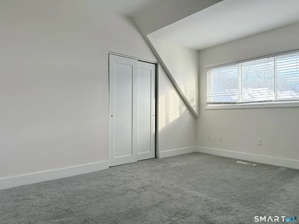 a bathroom with a sink window and a mirror