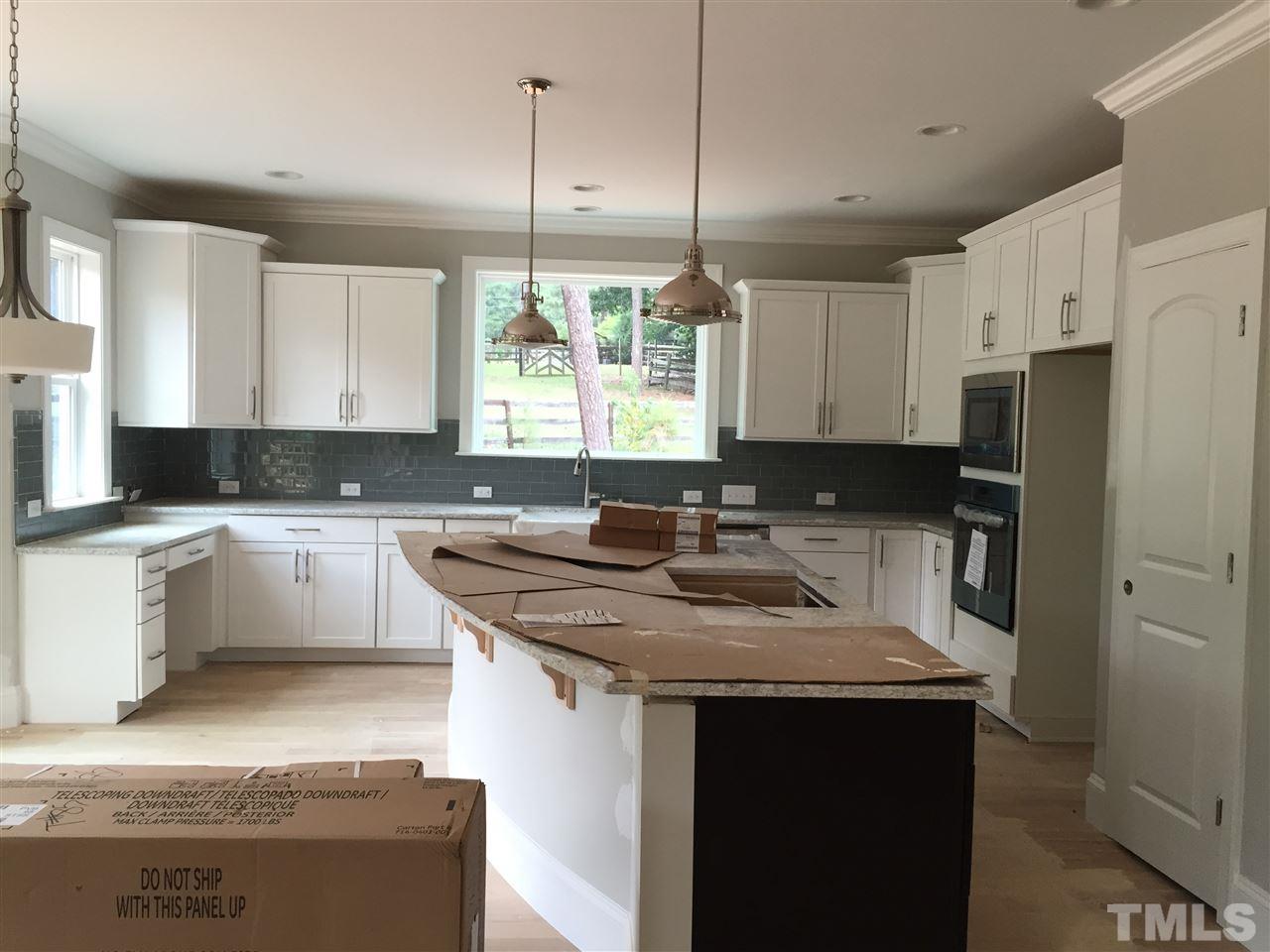 2016 Bowling Green Trail Raleigh, NC 27613 - Photo 6 of 20 a kitchen with a sink stove a refrigerator and a granite counter tops