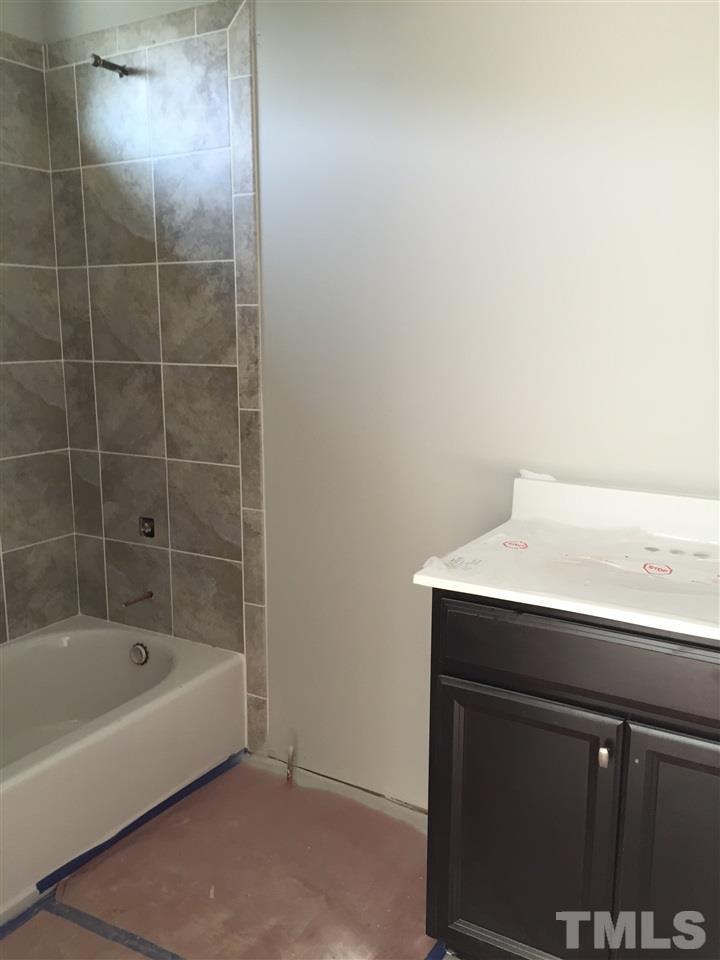 2016 Bowling Green Trail Raleigh, NC 27613 - Photo 9 of 20 a bathroom with a bathtub and a shower
