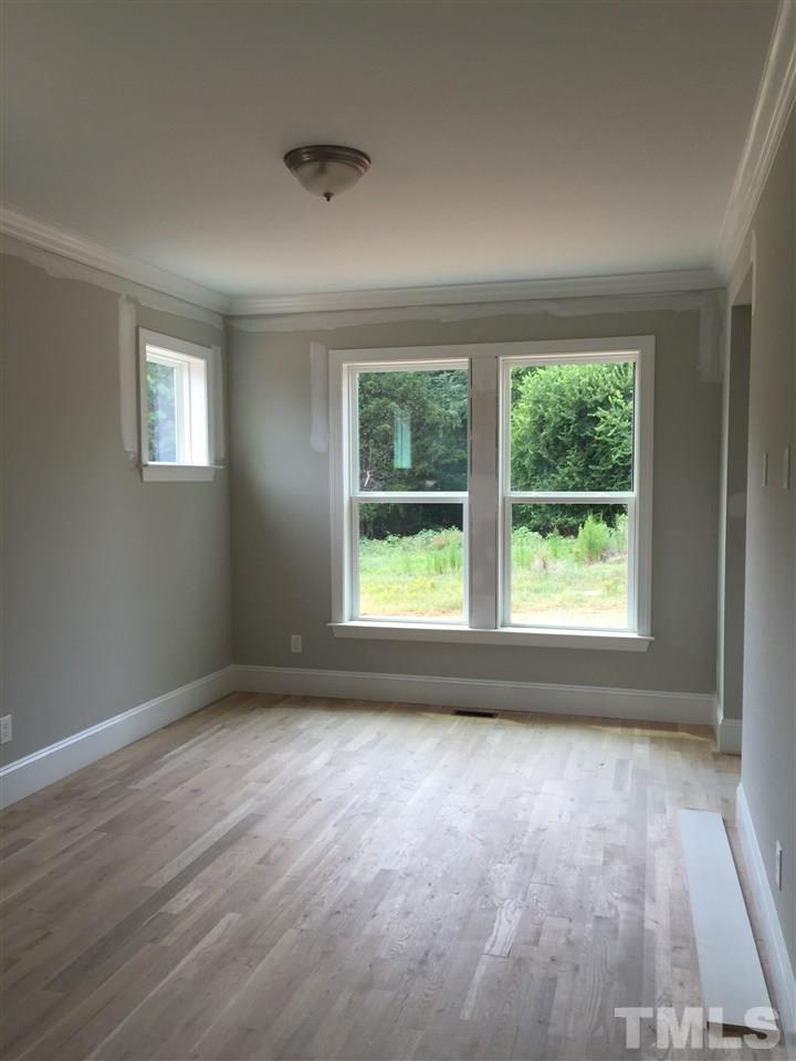 2016 Bowling Green Trail Raleigh, NC 27613 - Photo 10 of 20 a view of an empty room with wooden floor and a window