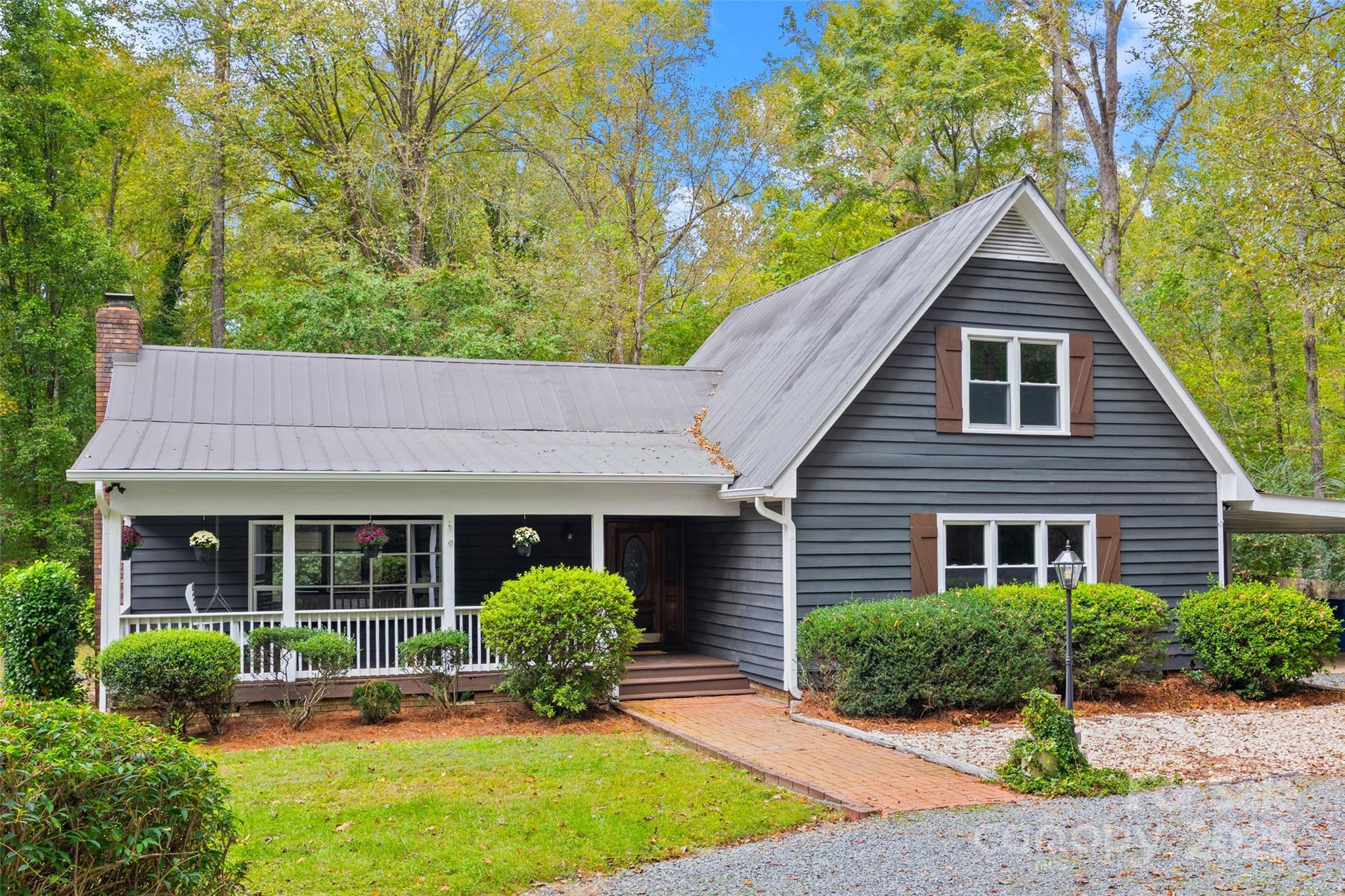 7301 Timber Ridge Drive Mint Hill, NC 28227 - Photo 1 of 37 a front view of a house with a yard and potted plants