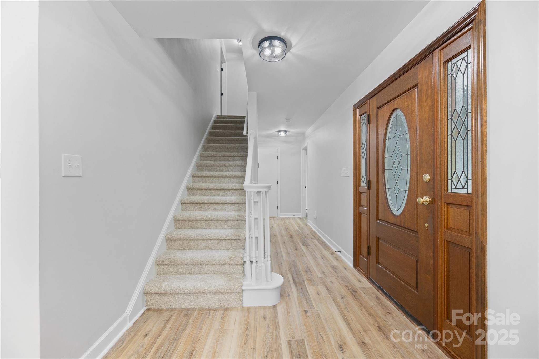 7301 Timber Ridge Drive Mint Hill, NC 28227 - Photo 13 of 37 a view of a hallway with wooden floor and entryway